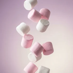 Pink and white vegan marshmallows tumbling through the air - Freedom Confectionery gelatine-free, Top 14 allergen-free mallows