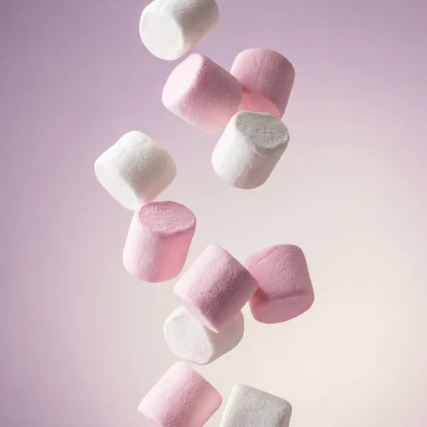 Pink and white vegan marshmallows tumbling through the air - Freedom Confectionery gelatine-free, Top 14 allergen-free mallows